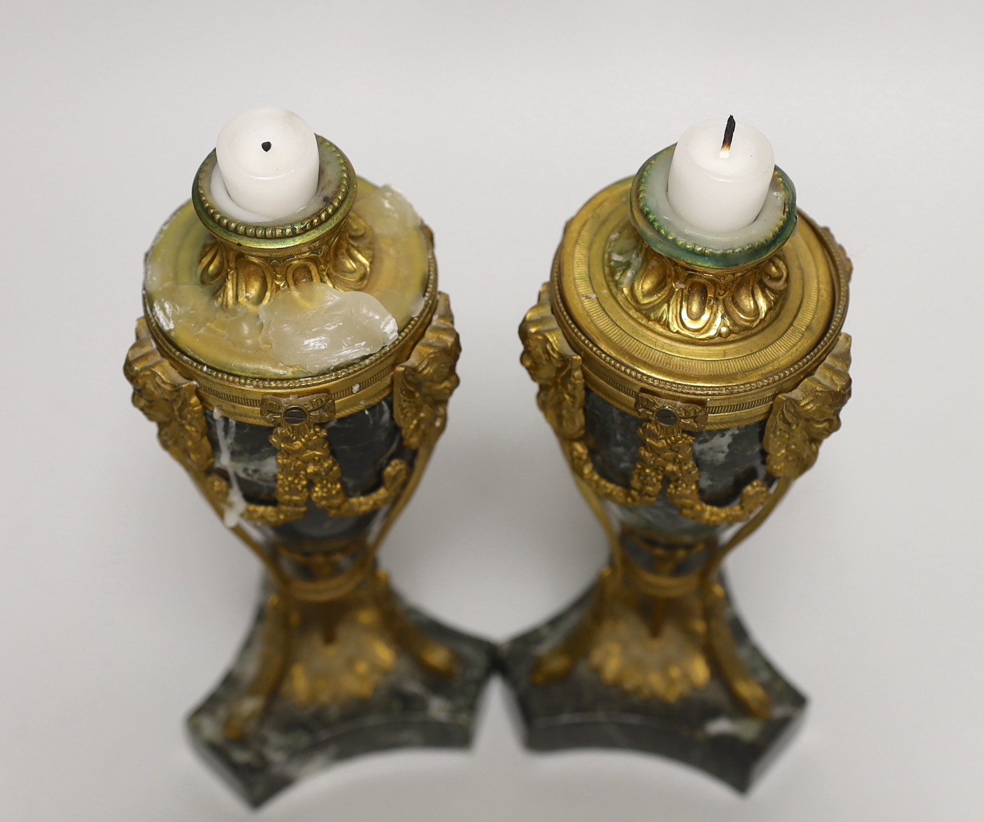 A pair of Regency style green marble and gilt metal cassolettes, decorated with bows and swags, each 24cm high